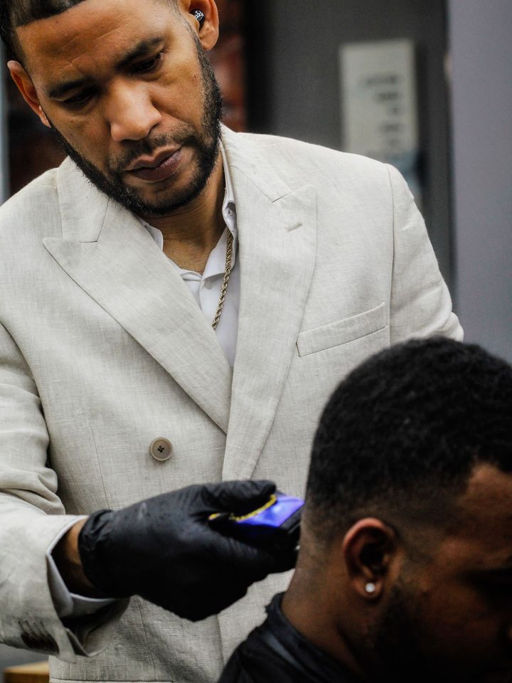 A barber edging a hairline with a trimmer