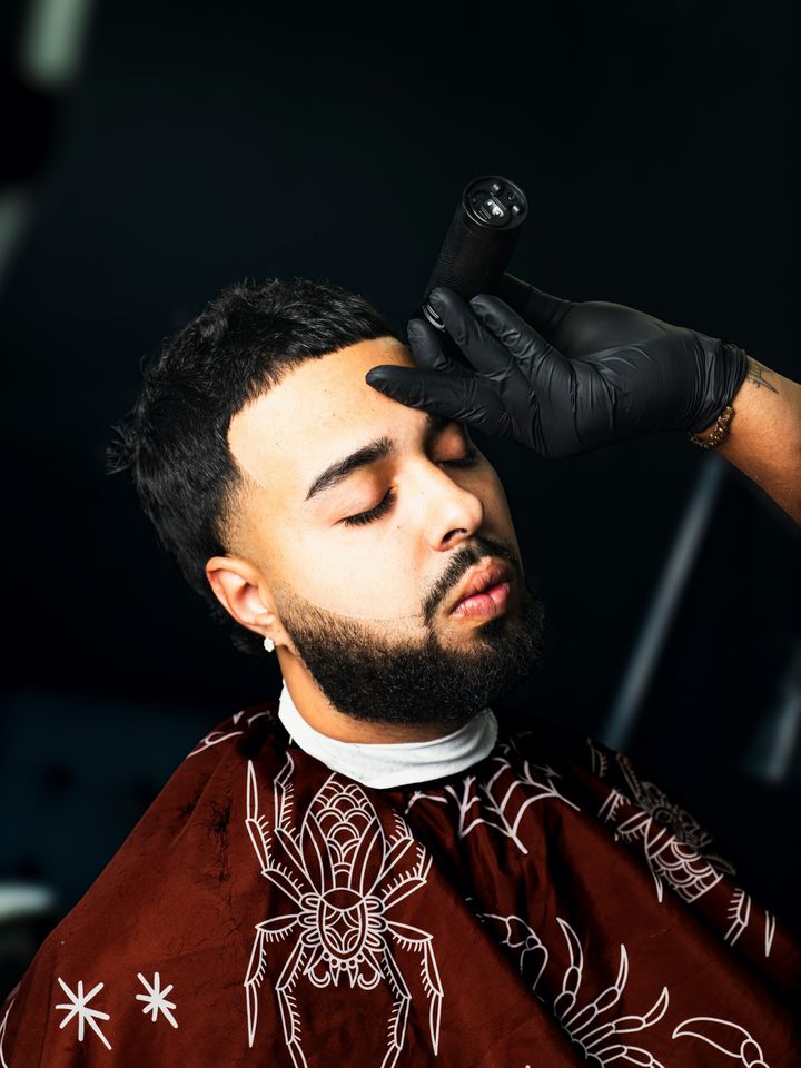 A beard being shaped in the chair