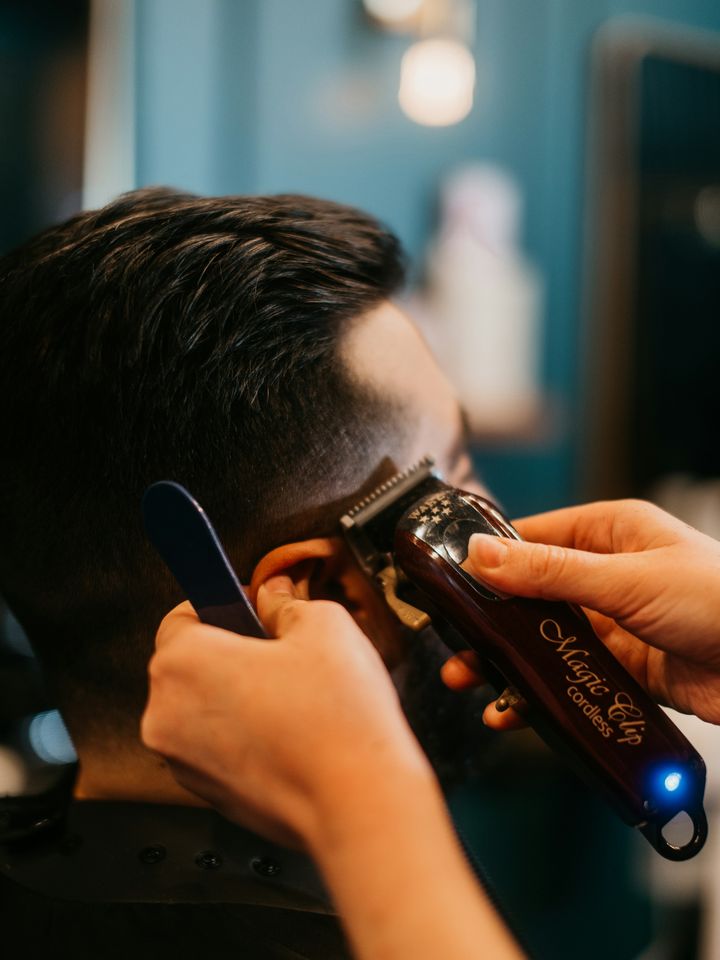 Clippers working along the side of the head