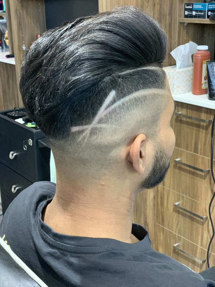 A fade with a shaved hard part