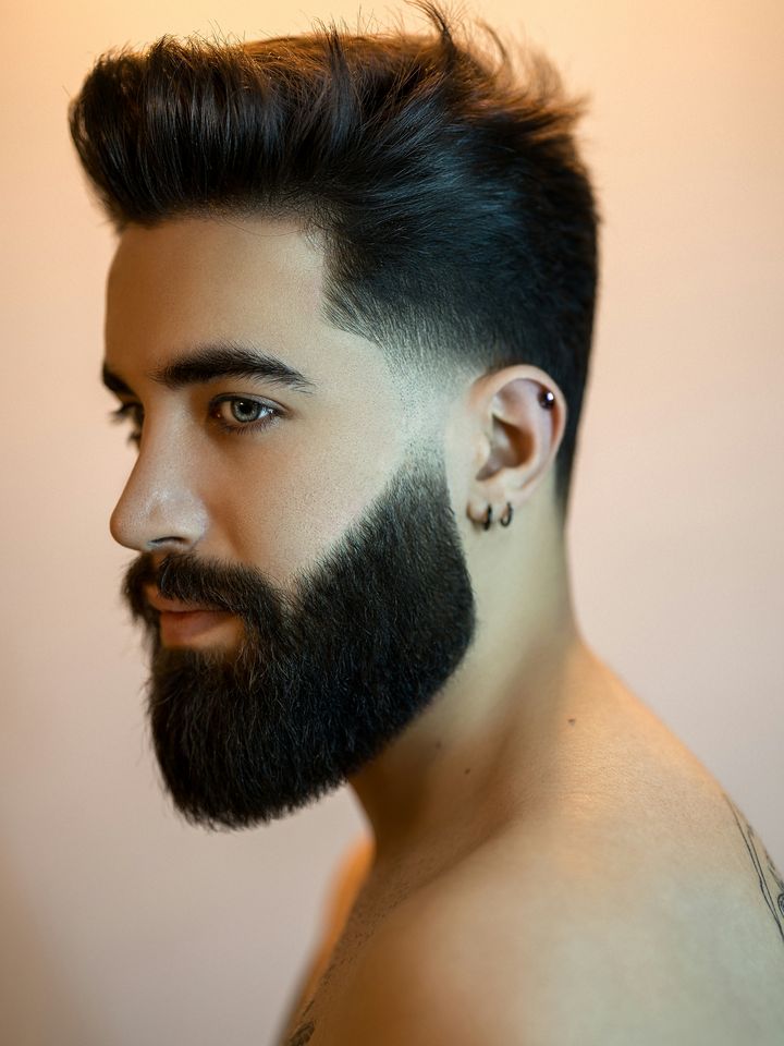 A tall quiff with a full beard
