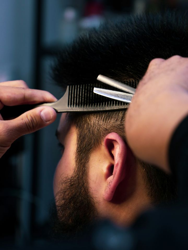 Scissors over a comb at the back of the head