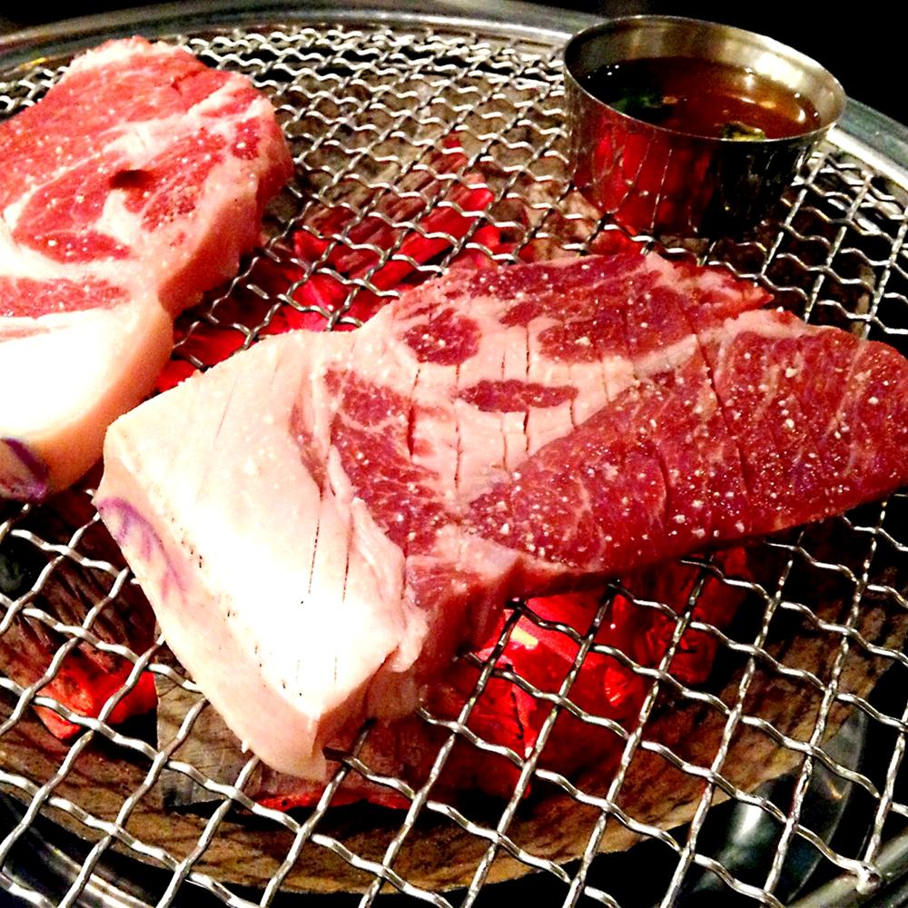 Beef and pork belly on the charcoal grill at Bulbit