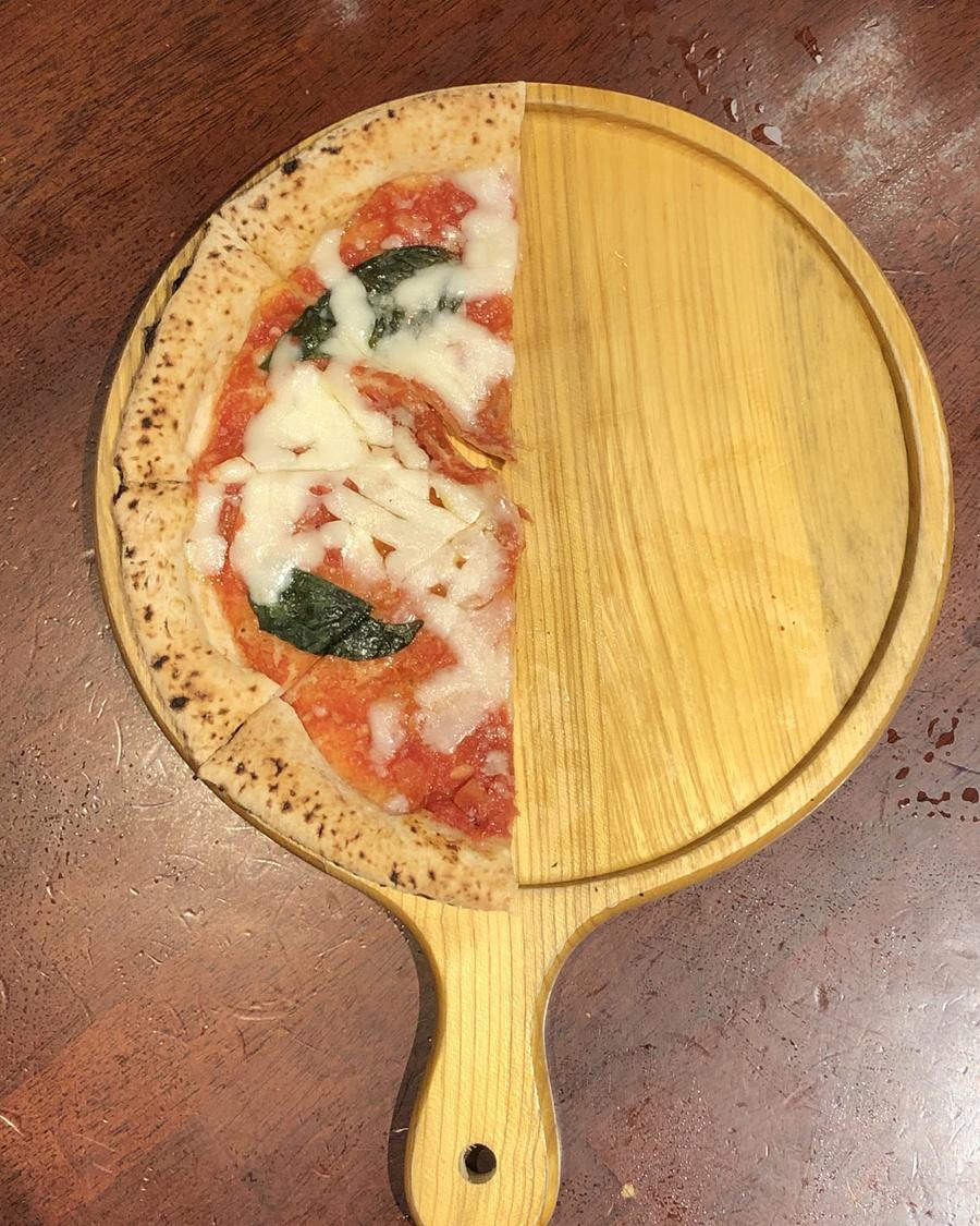 A margherita on a wooden pizza peel