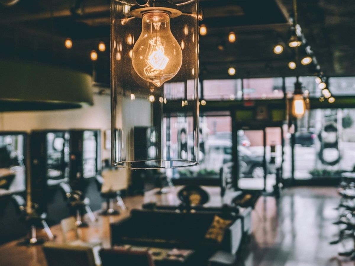 Inside the salon: chairs, mirrors and warm lights