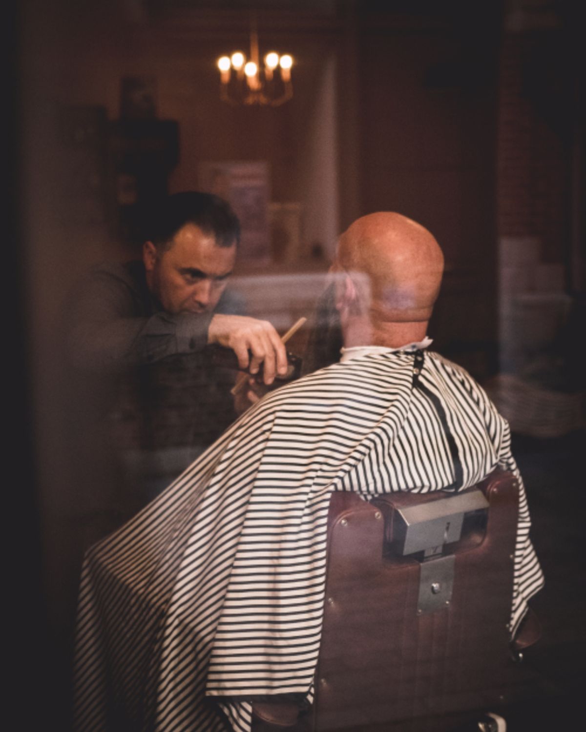 A barber cutting a client's hair